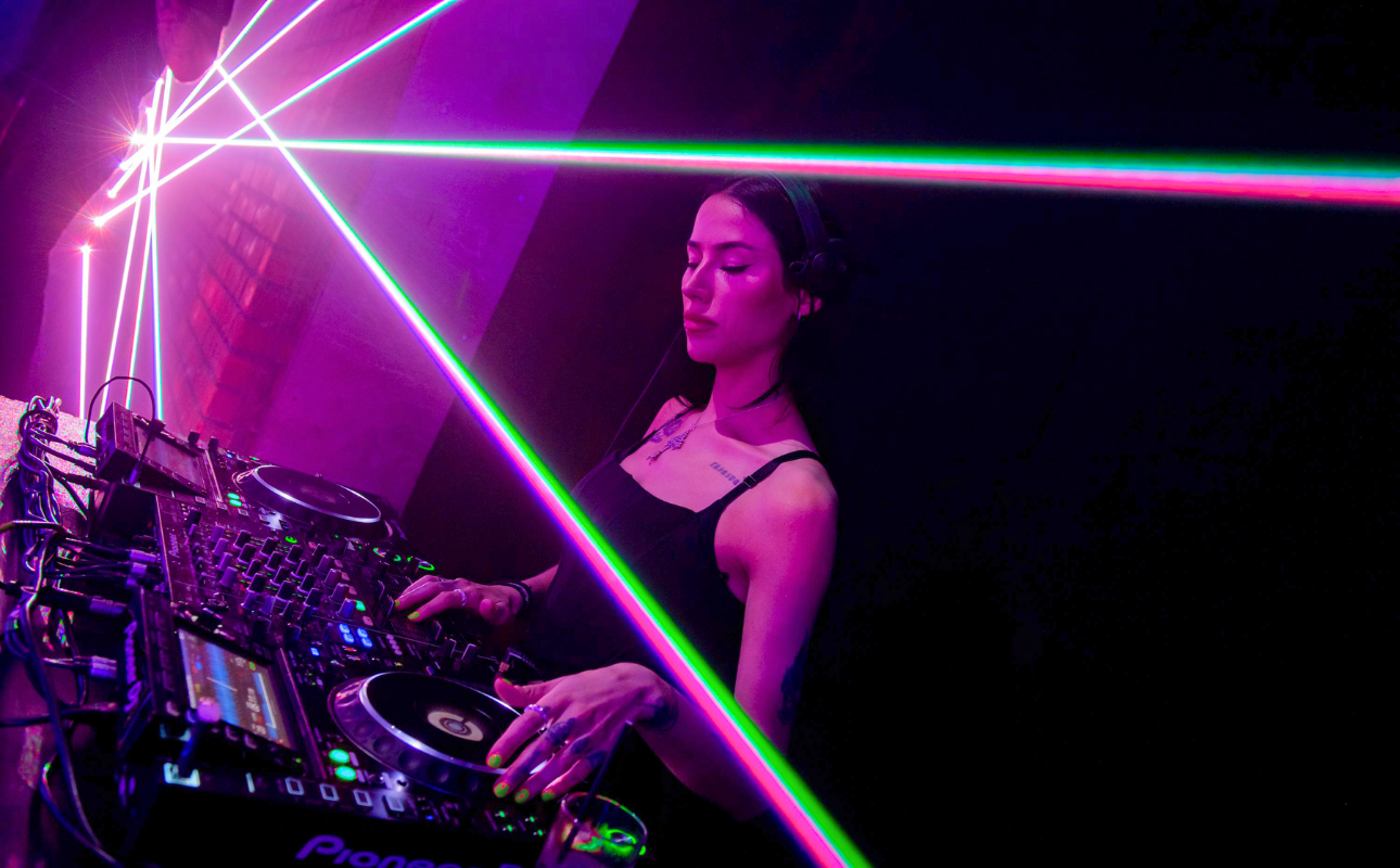 Charli XCX BRAT themed Christmas party with female DJ and pink and green laser lights, styled by expert Christmas party planners.