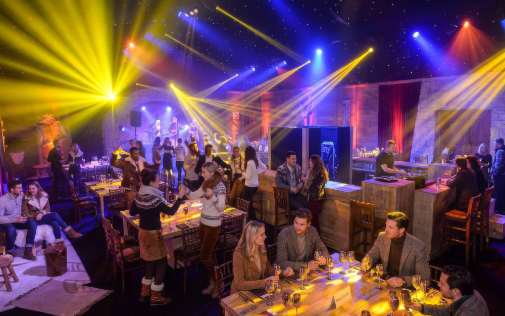 Guests enjoying a Taylor Lynn Corporation corporate Christmas party with live music, dining and colourful event lighting.